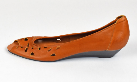 tan sandle with triangle shaped holes and open toe shown from the side