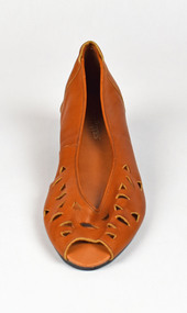 tan sandle with triangle shaped holes and open toe shown from the front