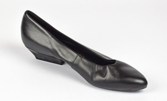 side view of a black heeled leather shoe