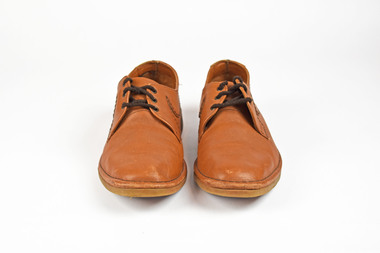 front view of two tans shoes with brown laces