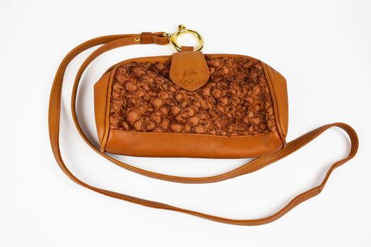 front view of brown textured bag with strap 