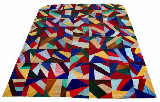 front of multi-coloured unfolded quilt with geometric pattern
