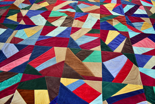 front of multi-coloured quilt with geometric pattern