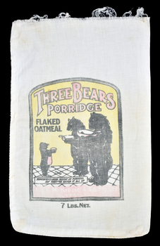 front of calico bag showing yellow, black and red graphic which includes three bears holding bowls