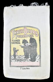 front of calico bag showing yellow, black and red graphic which includes three bears holding bowls