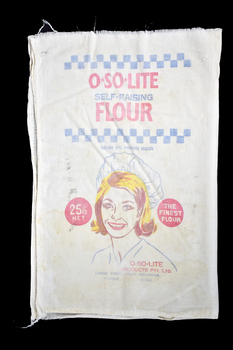calico bag with red, yellow and blue graphic and text, graphic shows woman wearing a bakers hat