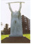 White sculpted figure of a soldier holding a rifle above his head. The statue stands on a red plinth.