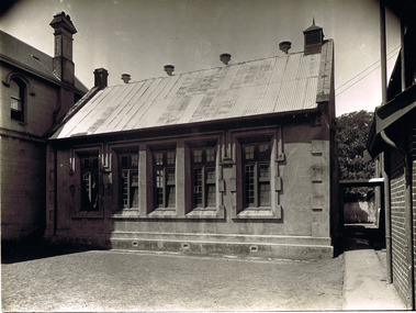 Single storey brick building with corrugated iron roof