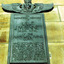 Green rectangular plaque with raised text mounted on stone. At the top of the plaque is the winged insignia of the Australian Flying Corps.