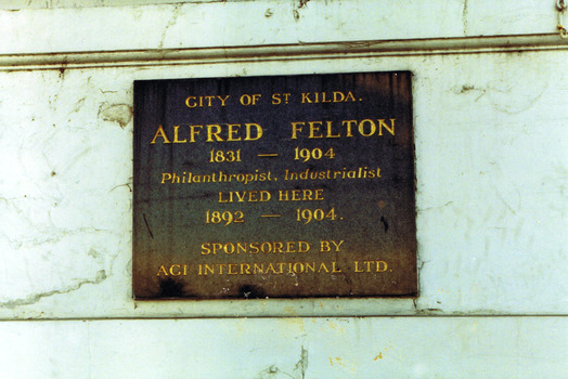 Rectangular metal plate inscribed with gold text