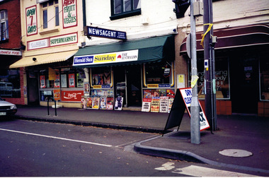 A supermarket, news agency and hairdressing salon in adjoining buildings