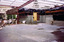 Metal beams extend from a building over concreted land.
