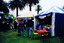 People visiting three gazebos in a park