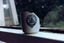 Side view of a white cup. It is cracked and missing the handle and almost half of the rim. It is decorated with a blue circular logo containing an image of a warrior on a horse and the words "George Hotel St Kilda"