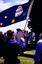 Man holding RSL flag, seen from behind