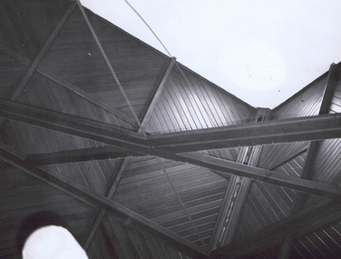 Interior view of rafters and panels of wooden ceiling 