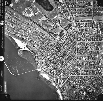 Rooftops, roads, trees, open spaces and St Kilda foreshore and pier seen from the air directly above.