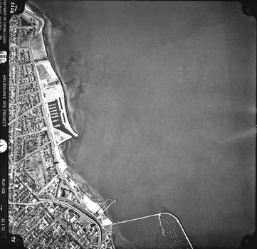 Rooftops, roads, trees, open spaces and St Kilda foreshore and pier seen from the air directly above.