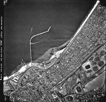 Rooftops, roads, trees, open spaces and St Kilda foreshore and pier seen from the air directly above.