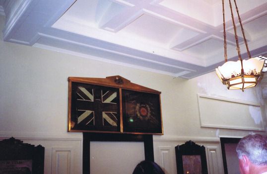 Two flags in a brass frame 