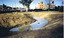A muddy pond in cleared land
