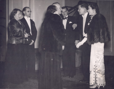 Black and white photograph showing WH Greaves and wife looking on as the Mayor and Mayoress greet two visitors.  A seventh person is also standing in the background.