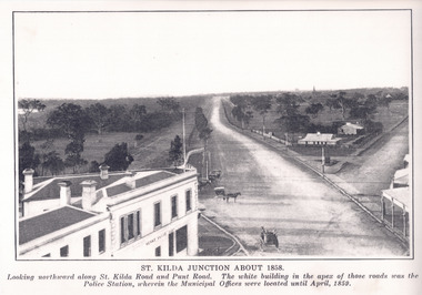 An early black and white photograph showing St Kilda Junction, looking north along St Kilda Rd and Punt Road.  There is a large building in the left foreground, possibly the Junction Hotel.  A single storey white building at the apex of the two roads is the original Police Station, where the municipal offices were located until 1859.  The police paddock is located adjacent to the police station.