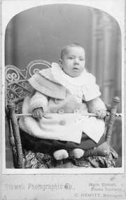 Photograph, C. Hewitt, Stawell Photographic Co, Mr. Don Raitt as a baby in a cane & seagrass chair c 1904