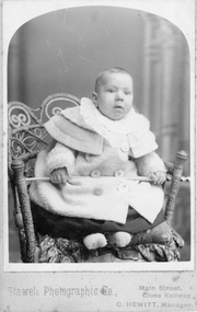 Photograph, C. Hewitt, Stawell Photographic Co, Mr. Don Raitt as a baby in a cane & seagrass chair c1904