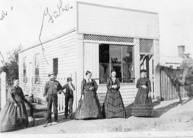 Photograph, Mr John Bird & Mary Cocking  -- possibly in front a Butcher Shop & Store