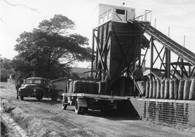 Photograph, Coke Hopper at the Gas Supply Company with bagged Coke on back of truck, 1945-50