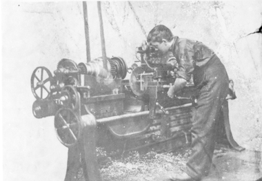Photograph, Workman using belt driven Lathe at the Wimmera Motor Works