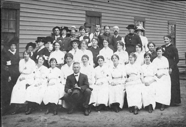 Photograph, Group of people (Red Cross?) in front of weatherboard building 1918