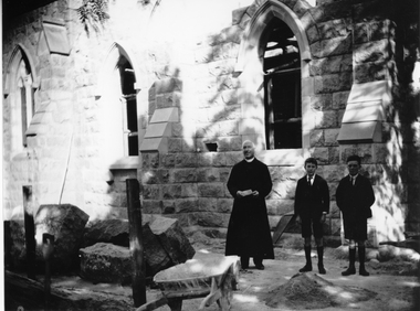 Photograph, St. Patrick’s Church Sanctuary under construction with the priest and two boys watching