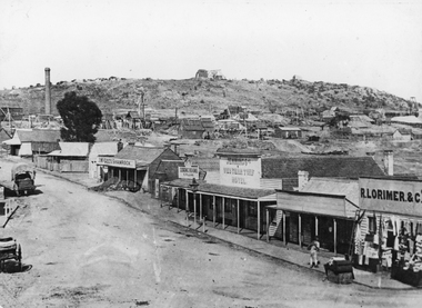 Photograph, Streetscape of South side of Upper Main Street Reefs Stawell looking East from around Patrick Street corner with Big Hill Mining in background c 1867