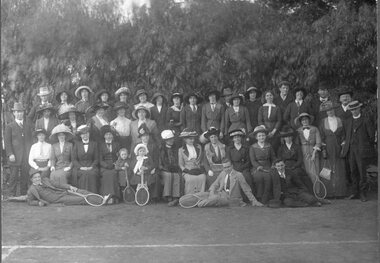Photograph, Tennis Club with minister standing on the right end.    It may be a church club