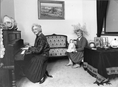 Photograph, Pleasant Creek Court House with Stawell Historical Society President Margaret Mason at the Piano & Treasurer Mari Van Leeuwen with the doll 1989