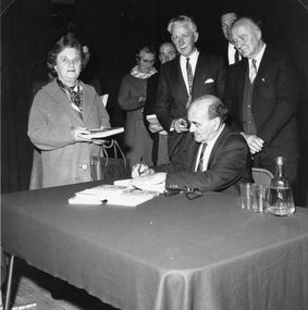 Photograph, Shepherd’s Gold Book with its Author Mr C E Sayers signing copies 1966