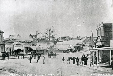 Photograph, Upper Main Street looking East with Poppet Heads in the background, the Oriental Bank second on left & then Quartz Reef Timber Yard 1866