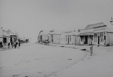 Photograph, Upper Main Street with the London Chartered Bank on the right, Mr W Muir Produce Dealer & the  Bank of Victoria 1866