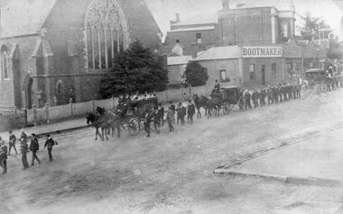 Photograph, Mr Stanley Morris Barwise's Funeral Procession in Main Street Stawell in front of the Anglican Church with horse drawn carriages used by Mr Frank Crouch 1911
