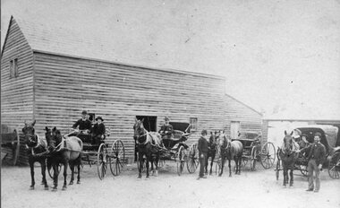 Photograph, Weather Board Barn or Business with Horse-drawn Vehicles at the front
