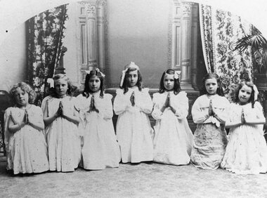 Photograph, Group of Children on Stage -- possibly a Sunday School Concert with Miss Irene May Berndt on the left c1910