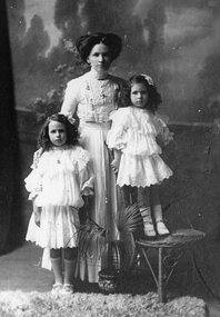 Photograph, Mrs Henrietta May Frawley (nee Stephens) of Clunes with her two daughters, Margaret Mary Frawley (known as May) & Willfra Lillias Frawley 1911 -- Studio Portrait