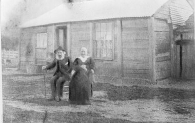 Photograph, Mr William Currie & Mrs Mary Ann Currie nee Unknown in front of their Timber Slab Home c1910