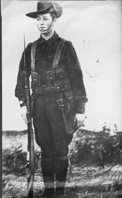 Photograph, Mr Sydney Davidson as a Soldier in WW1 in uniform with rifle, webbing, & map case 1914-1918 -- Studio Portrait