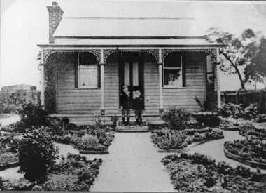 Photograph, Mr George Robson's miners cottage home showing 2 boys on the verandah -- on the corner of Barnes & Cypress Streets Stawell