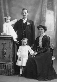 Photograph, Mr Tom Goldsworthy with his wife and two children -- Studio Portrait