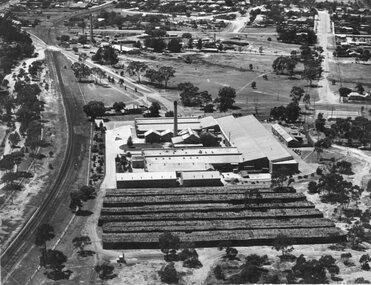 Photograph, North Western Woollen Mills -- Aerial View Showing Wood pile and train line at left