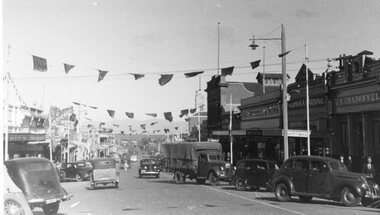 Photograph - Upper Main Street looking West, Upper Main Street with Bunting looking West & Named Shops in 2nd Photo -- 2 Photos